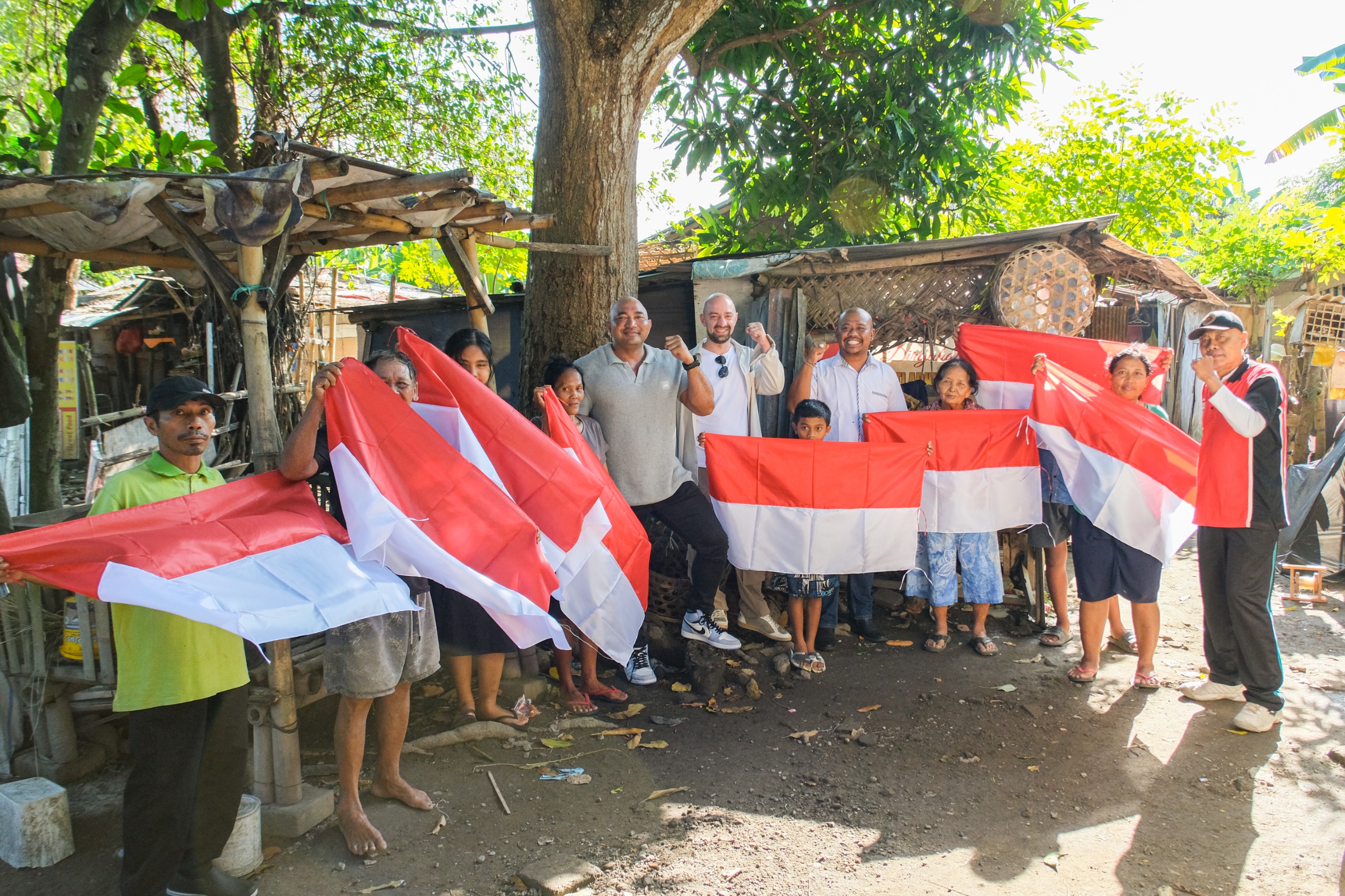 Made Mulaiawan Arya alias De Gadjah membagikan bendera ke masyarakat untuk menyaambut Hari Ulang Tahun Indonesia ke 80 tahun di Denpasar, 16 Agustus 2025. Photo/Okedaily.com